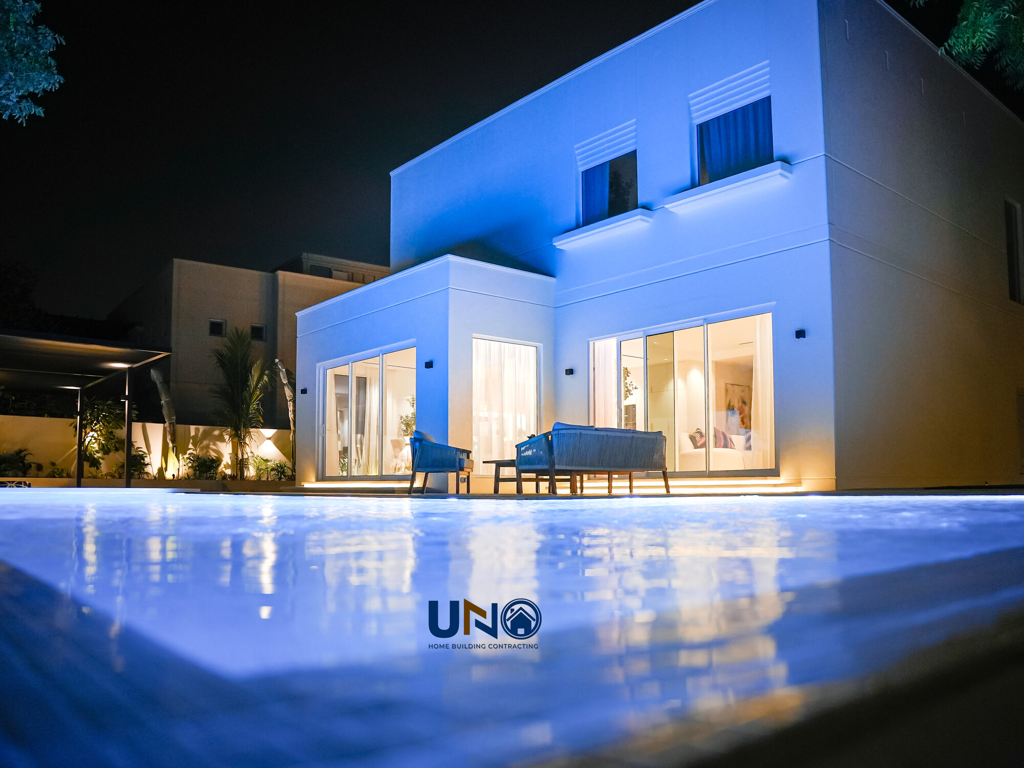 The Meadows villa exterior at dusk with the new pool lit