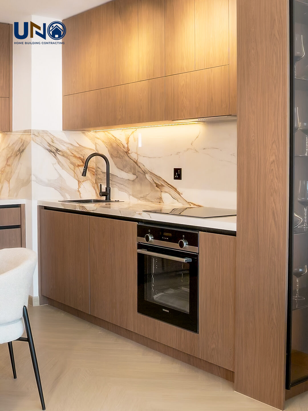 Kitchen with warm timber joinery and a marble splashback